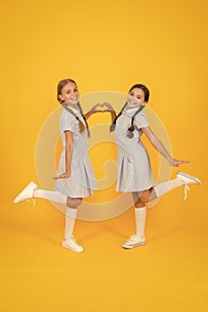 Sisterhood love. children in vintage style. old school. happy friends on yellow background. kid fashion. childhood