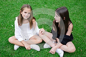 sisterhood. two sisters or friends spending time outdoors on sunny summer day. bff, sibling, girlfriend. millennial teen