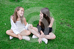 sisterhood. two sisters or friends spending time outdoors on sunny summer day. bff, sibling, girlfriend. millennial teen