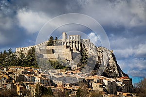 Sisteron Citadel, fortifications and rooftops with clouds. Southern Alps, Franc photo