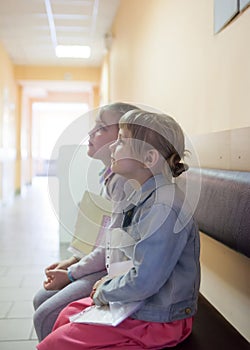 Sisters in children`s hospital  waiting for   doctor