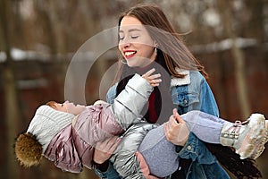 Sisters of different ages have fun in the winter walk