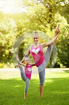 Sisters doing exercise outdoors. Healthy lifestyle