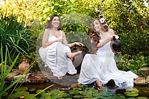 Sisters draw water from a pond.