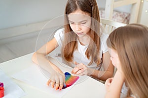 Sisters drawing rainbow. stay at home. photo