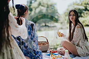 Sisters enjoying a peaceful picnic in the park on a sunny day