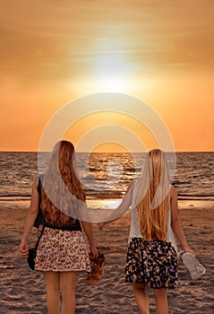 Sisters enjoying time together on beautiful foggy beach