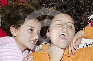 Sisters fighting in bed