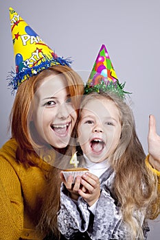 Sisters four and eighteen years old at birthday.