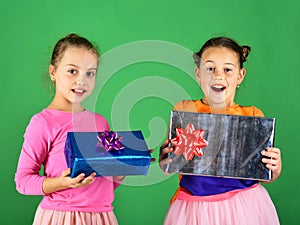 Sisters with gift boxes for holiday. Children with happy faces