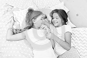 Sisters happy small kids relaxing in bedroom. Friendship of small girls. Leisure and fun. Having fun with best friend