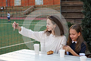 Sisters have snack at sports field