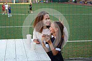 Sisters have snack at sports field
