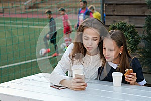 Sisters have snack at sports field