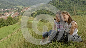 Sisters on hillside, Copsa Mare, Transylvania, Romania