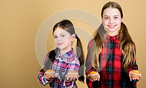 Sisters hold baked muffins. Homemade food. Diet healthy nutrition and calorie. Yummy muffins. Girls cute kids eating