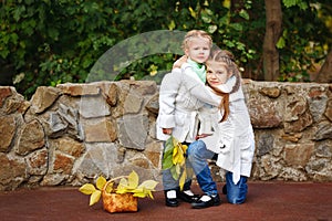 Sisters hugging in autumn park.