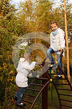 Sisters hugging in autumn park.