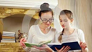 Sisters with interest spending time after book reading, girls spend free time together