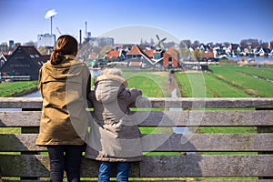 The sisters look at wind mills in Zaanse Schans