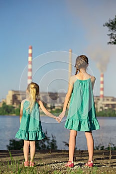 Sisters looking at the plant chimney-stacks