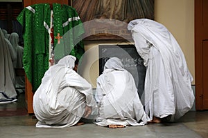 Sisters of Missionaries of Charity preparing for prayer in Motherhouse, Kolkata photo
