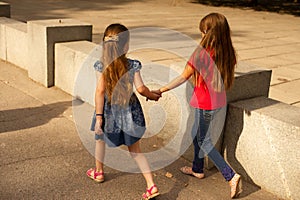 Sisters, Outdoor photo from two little girls. Two little girls walk in the park by the hand. Girlfriends, children