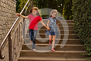 Sisters, Outdoor photo from two little girls. Two little girls walk in the park by the hand. Girlfriends, children