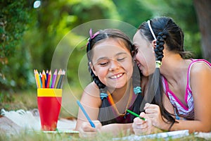 Sisters reading book in summer park