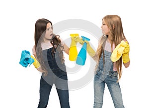 Sisters rivalry. Who did better. Girls with yellow rubber protective gloves ready for cleaning. Household duties. Little
