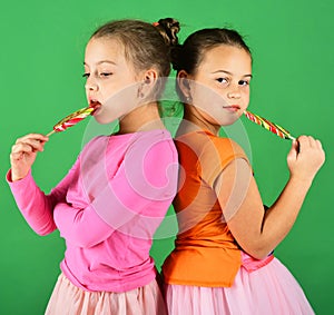 Sisters with round and long shaped lollipops