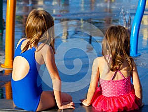 Sisters Sit at a Splash Pad