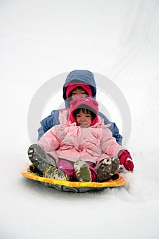 Sisters tobogganing