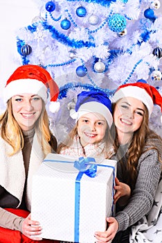 Sisters unpack big gift box. Girls with happy faces