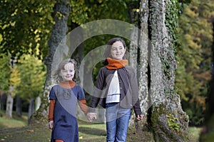 Sisters walking on a path in the forest