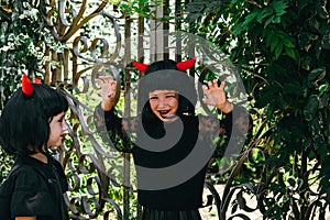 Sisters wearing wigs with red horns  Halloween celebration party portrait