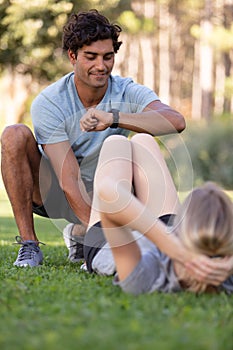 sit ups fitness couple exercising sit up outside in grass photo