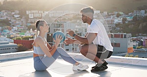 Sit ups, fitness and personal trainer with a woman on a rooftop of a city building training with a medicine ball