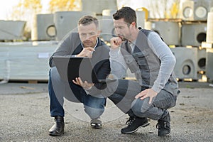 Site manager checking planning on computer