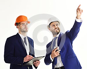 Site manager and construction manager in helmets.