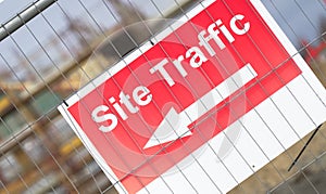 Site traffic direction sign at construction site entrance