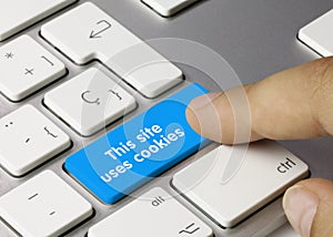 This site uses cookies - Inscription on Blue Keyboard Key.