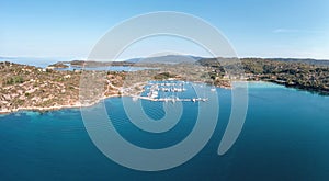 Sithonia Chalkidiki, Greece. Ormos Panagias bay and boat marina aerial drone view, sunny summer day