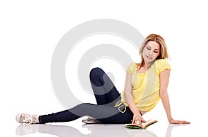 Siting teen girl reading book photo