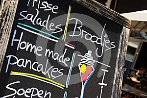 SITTARD, NETHERLANDS - JUIN 29. 2019: Close up of hand written menu on black chalk board of durch restaurant