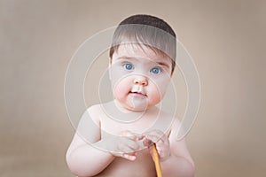 Sitting baby girl - eye contact with the camera