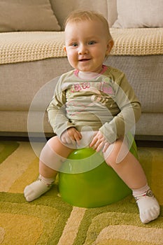 Sitting baby on potty