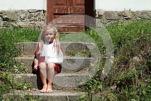 Sitting barefeet girl on the stairs