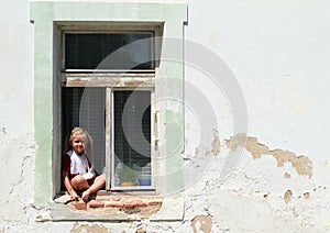 Sitting barefeet girl in a window with broken hand
