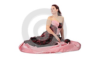 Sitting beautiful woman in luxurious dress